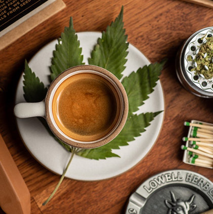 Cup of coffee with cannabis leaf